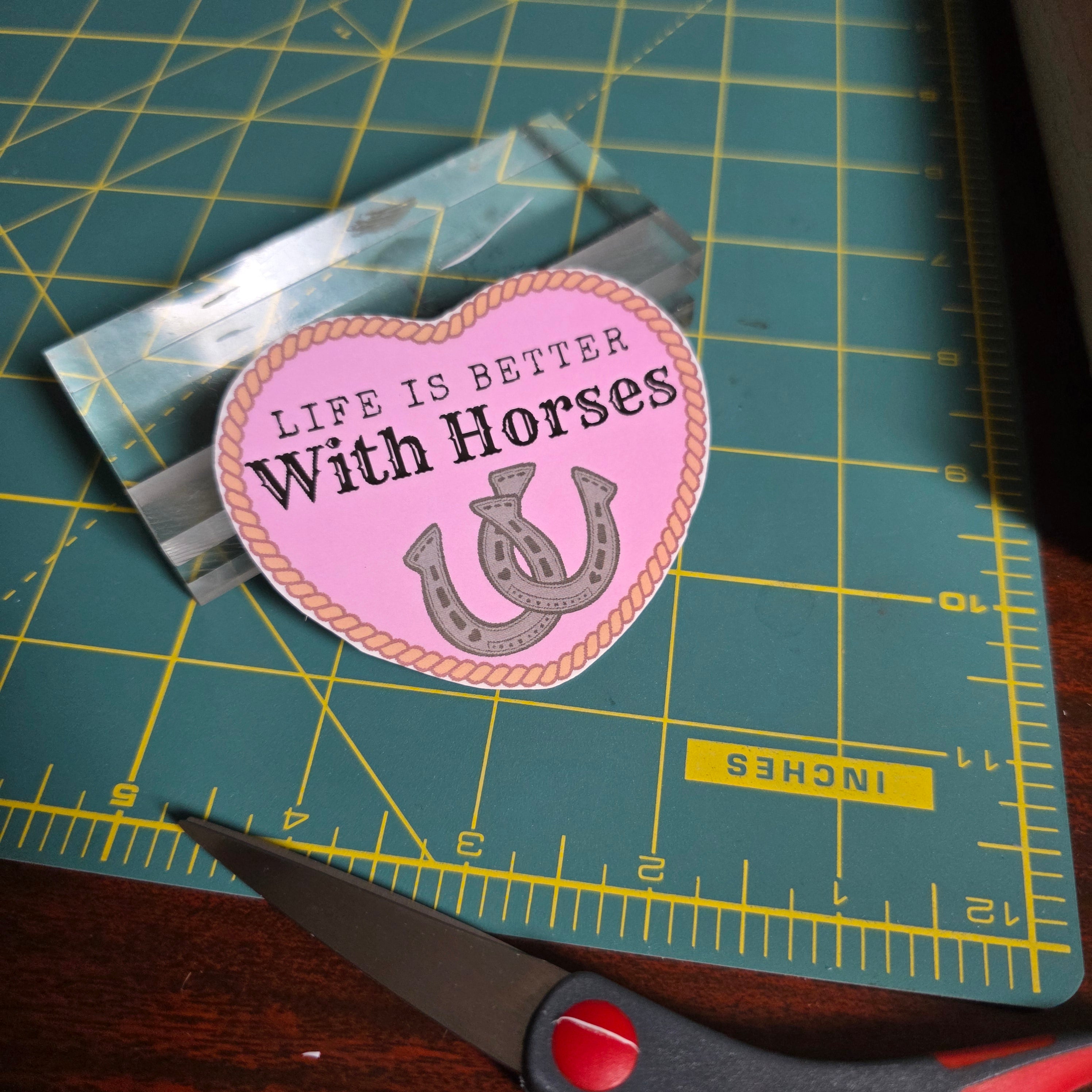 "Life is better with Horses" 3 x 2.75 inch light pink heart sticker. Small size.