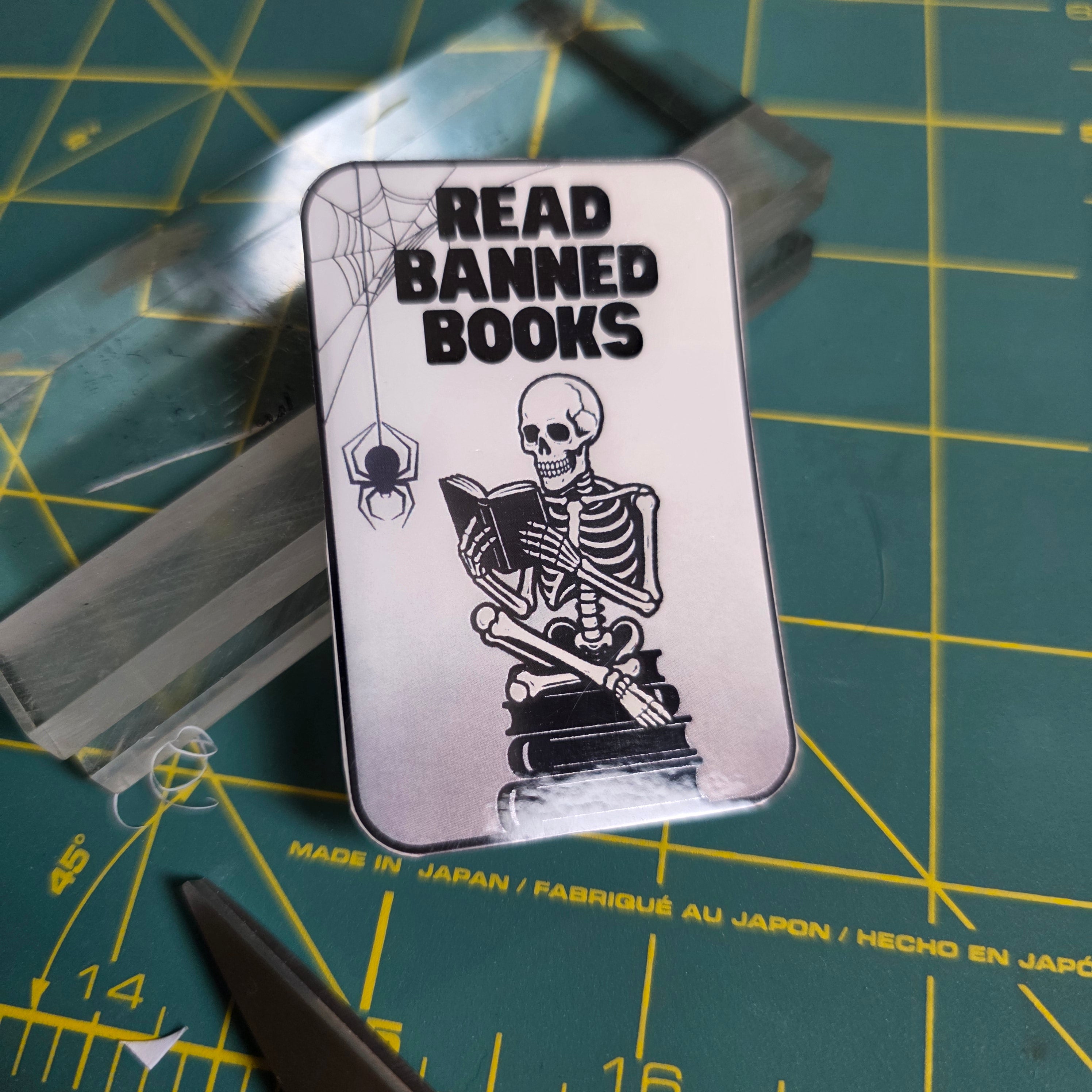 Skeleton and books "Read Banned Books"small sticker.