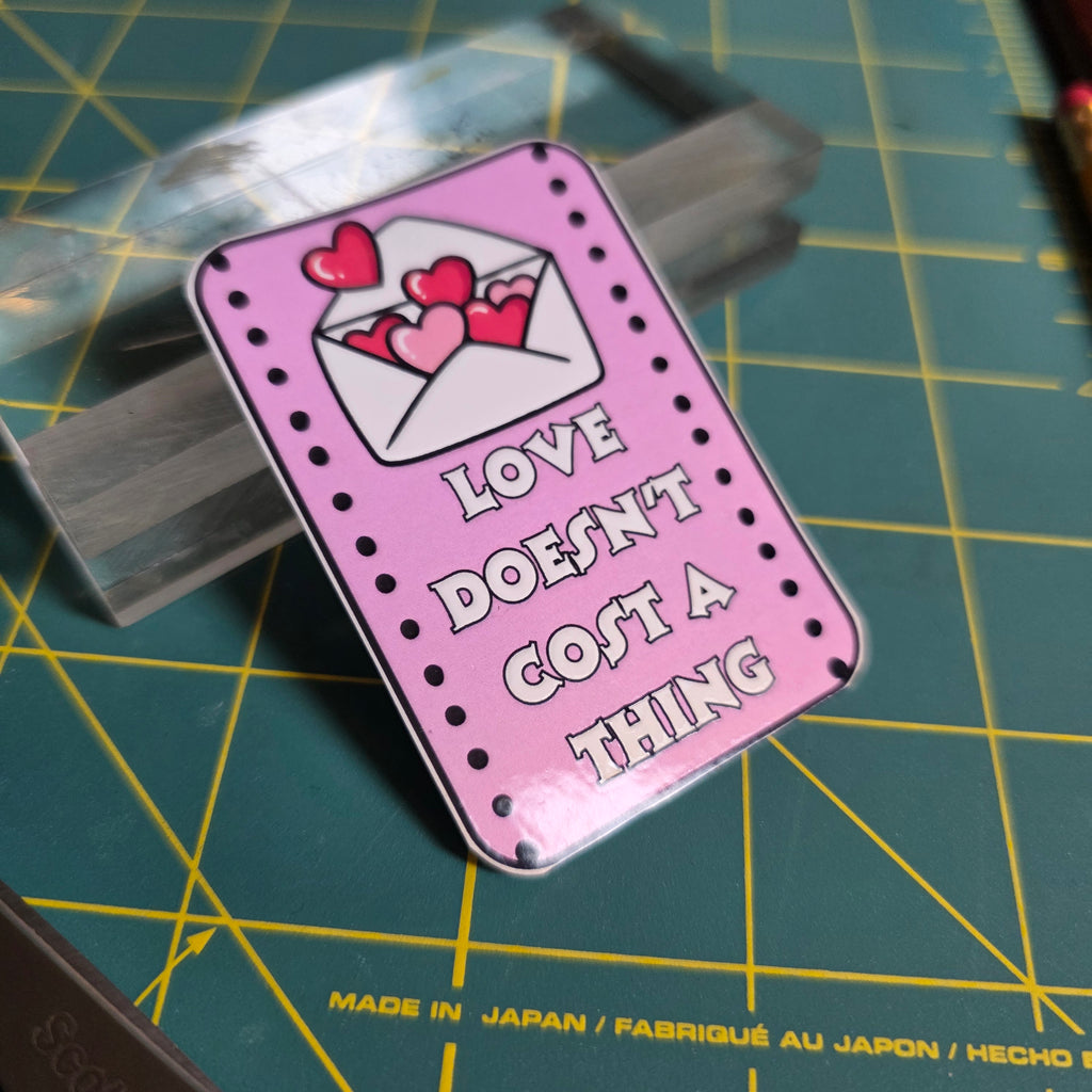 Love Doesn't Cost a Thing pink rectangular sticker.