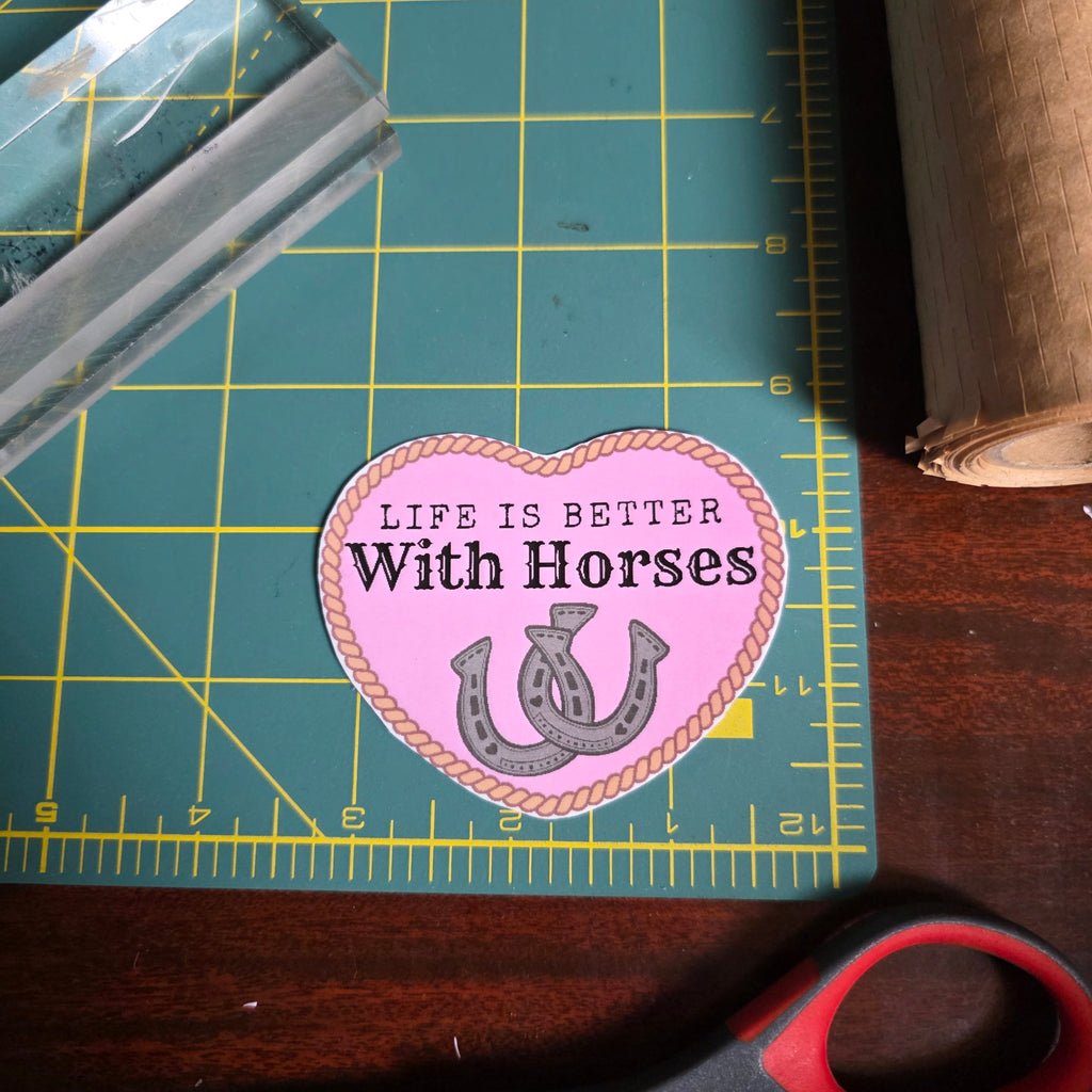 "Life is better with Horses" 3 x 2.75 inch light pink heart sticker. Small size.