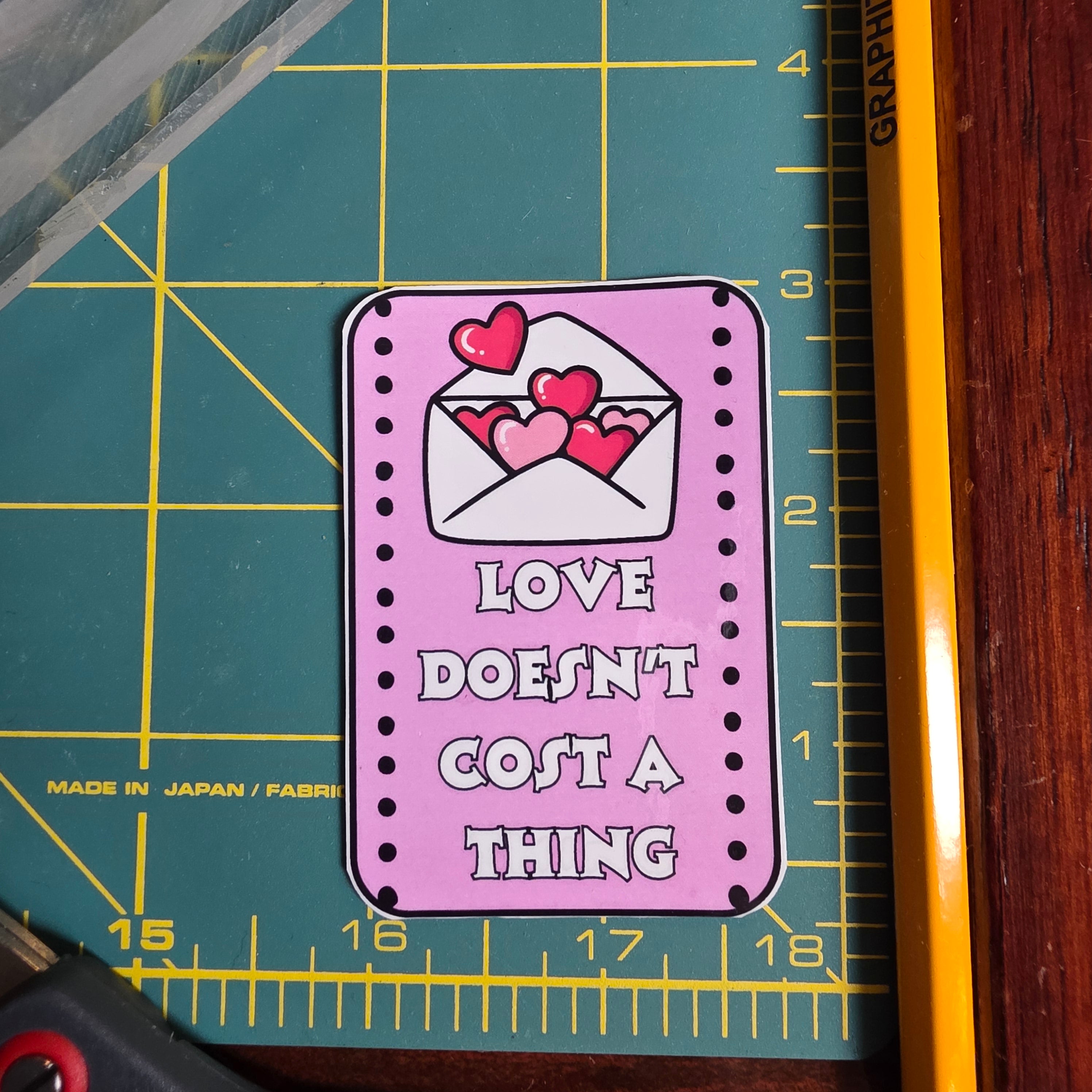 Love Doesn't Cost a Thing pink rectangular sticker.