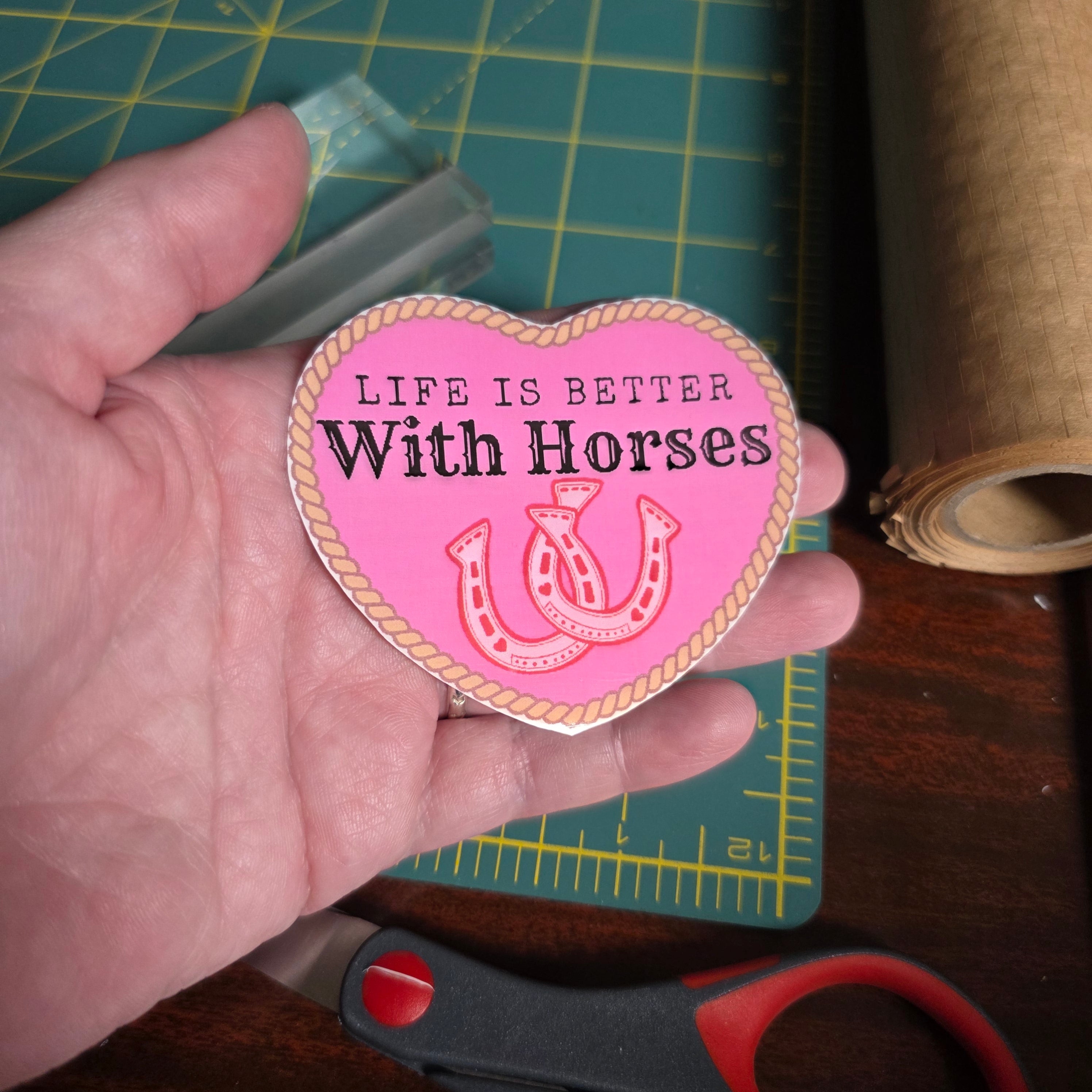 "Life is better with Horses" 3 x 2.75 inch light pink heart sticker. Small size.