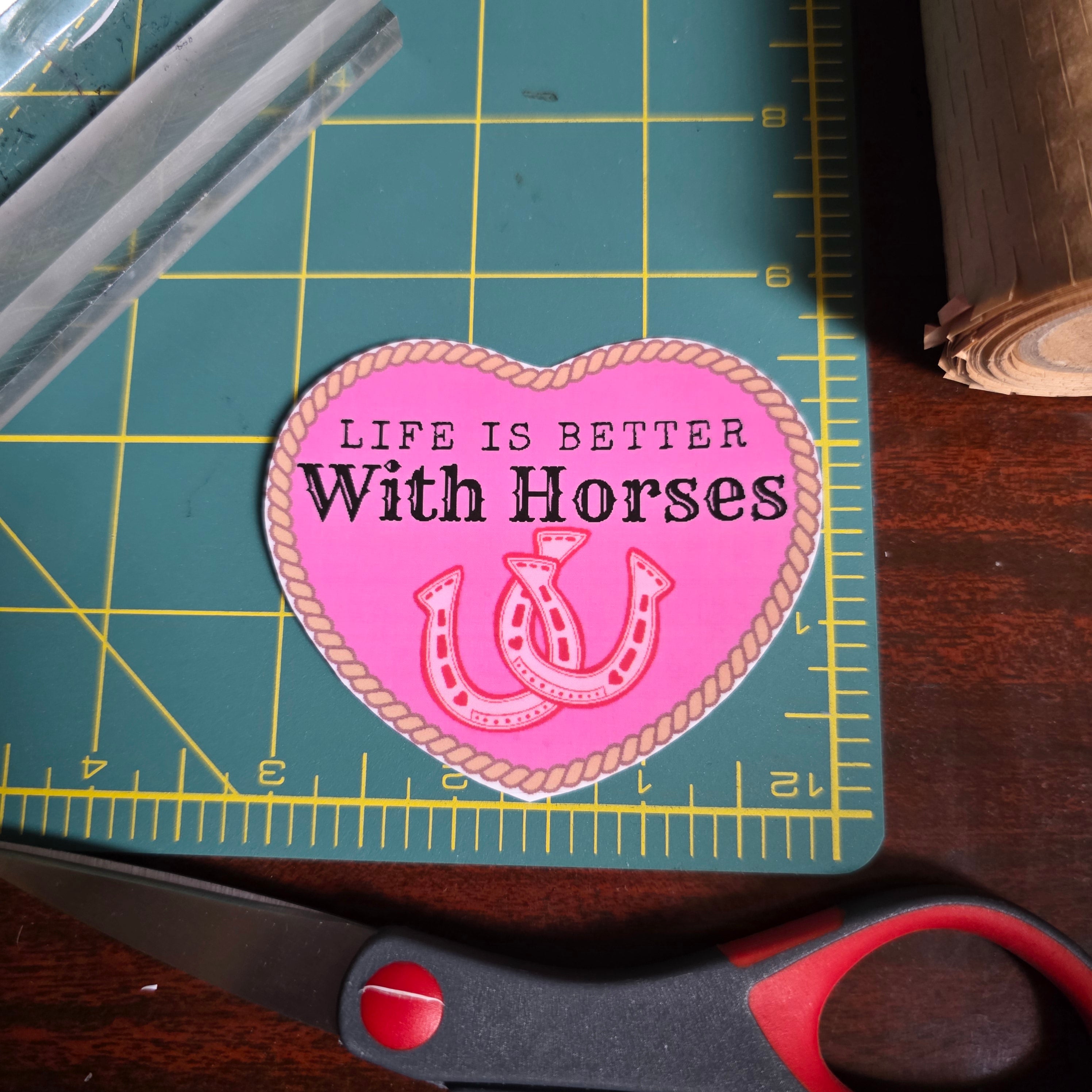 "Life is better with Horses" 3 x 2.75 inch light pink heart sticker. Small size.